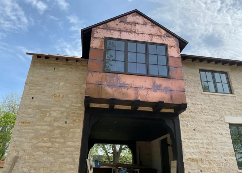 Copper metal panel facade on a stone building for Metal Roof Coating in Commerce